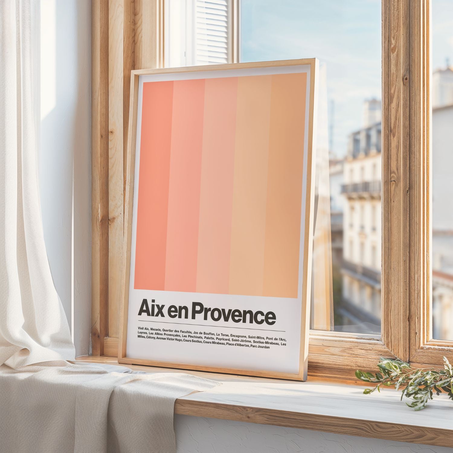 Framed artwork with 'Aix en Provence' text on a window sill.